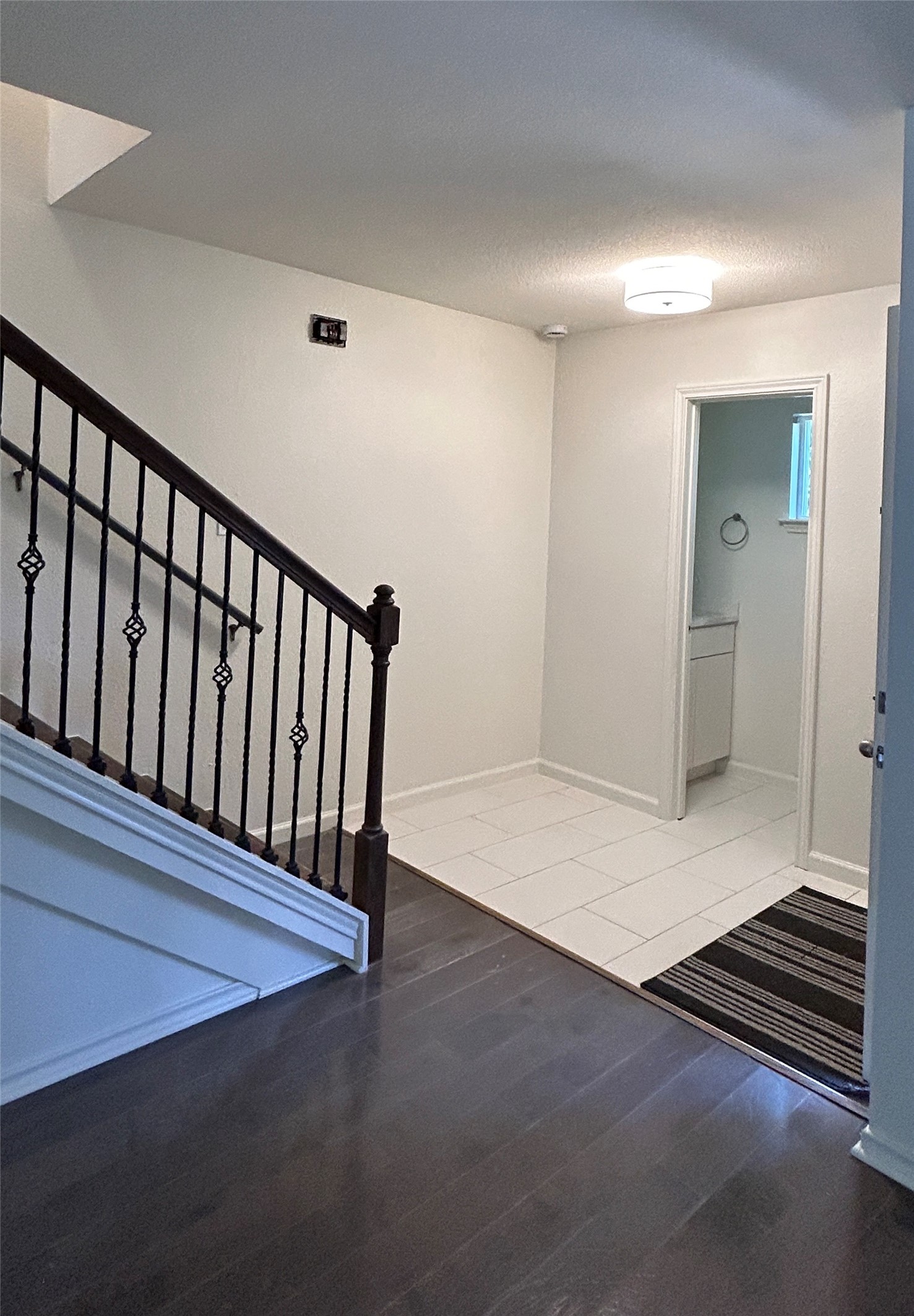 705 Castle Ridge Road, Unit C Austin, TX 78746 - Photo 14 of 15 Gleaming hardwood floors and a classic balustrade frame this welcoming entry area.