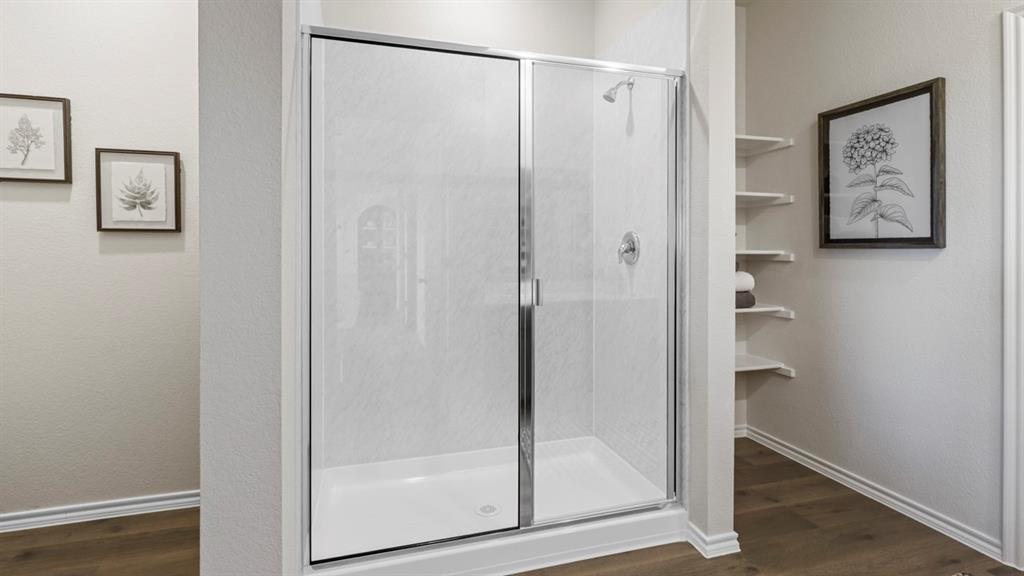 636 Dunham Road Nevada, TX 75173 - Photo 29 of 31 Shower enclosure with chrome-finish framing and clear glass panels, featuring a white shower base and a wall-mounted showerhead