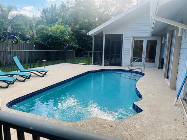 a view of swimming pool from a lounge chair