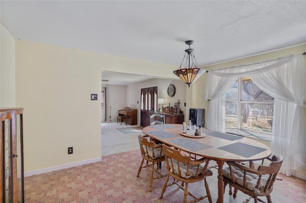 101 Frazier Oaks Road Pottsboro, TX 75076 - Photo 14 of 36 a view of a dining room with furniture window and wooden floor