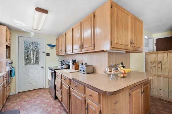 a kitchen with stainless steel appliances granite countertop a sink a stove and cabinets