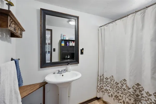 a bathroom with a sink and mirror