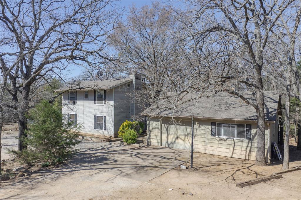 101 Frazier Oaks Road Pottsboro, TX 75076 - Photo 2 of 36 a front view of a house with a tree