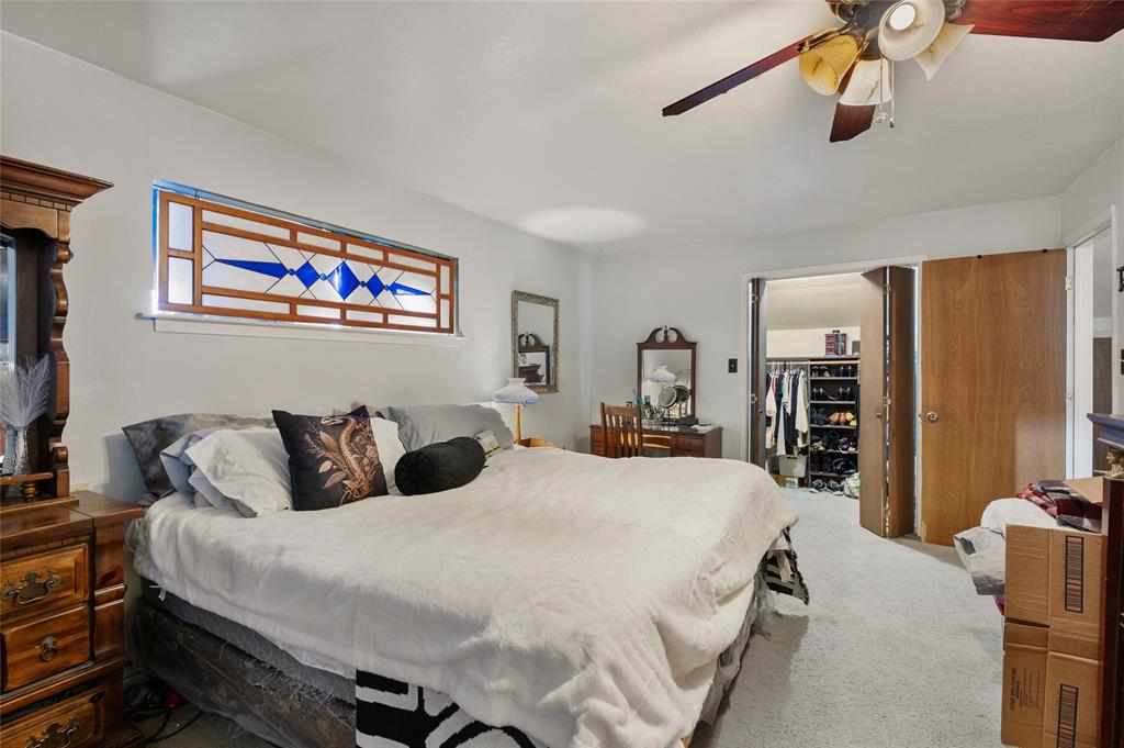 101 Frazier Oaks Road Pottsboro, TX 75076 - Photo 21 of 36 a bedroom with a bed a wall painting and a book shelf