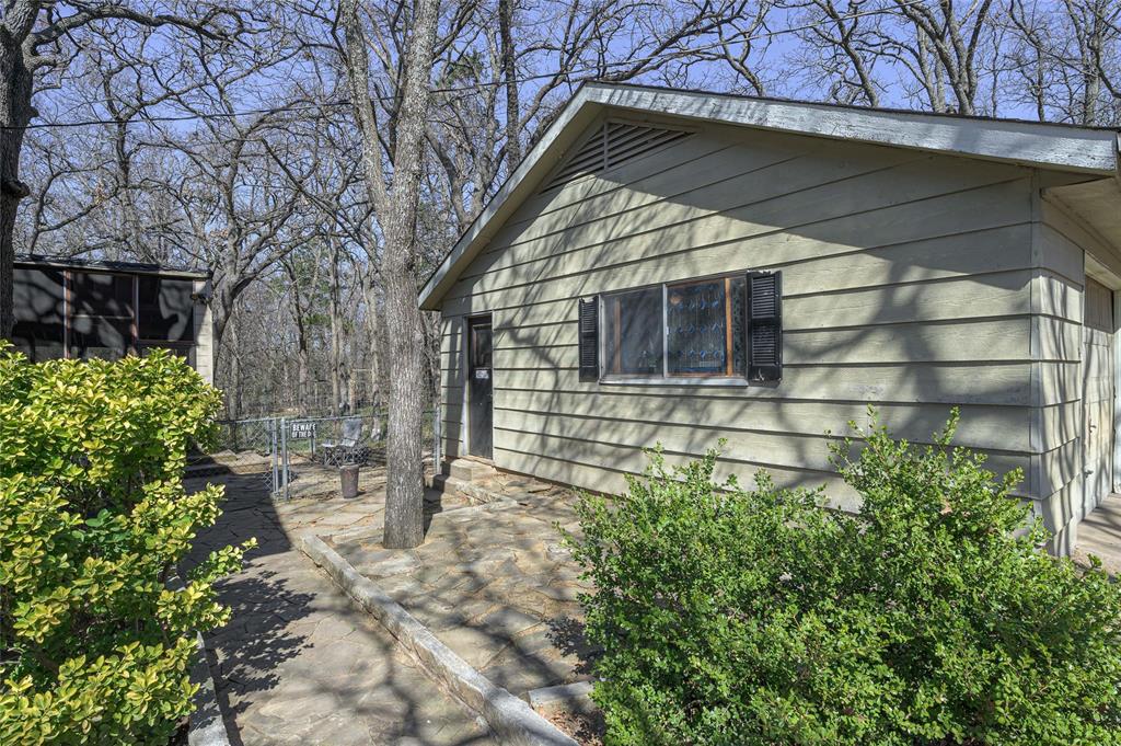 101 Frazier Oaks Road Pottsboro, TX 75076 - Photo 25 of 36 a house with trees in front of it