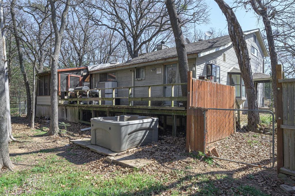 101 Frazier Oaks Road Pottsboro, TX 75076 - Photo 30 of 36 a view of a backyard with large tree and wooden fence