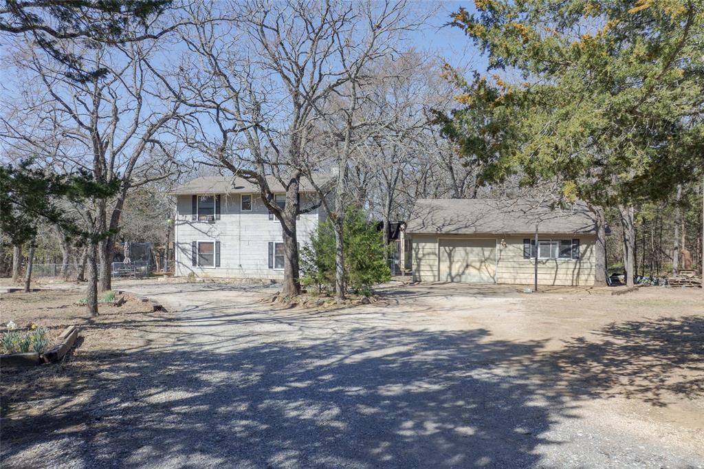101 Frazier Oaks Road Pottsboro, TX 75076 - Photo 3 of 36 a tree in front of a white house