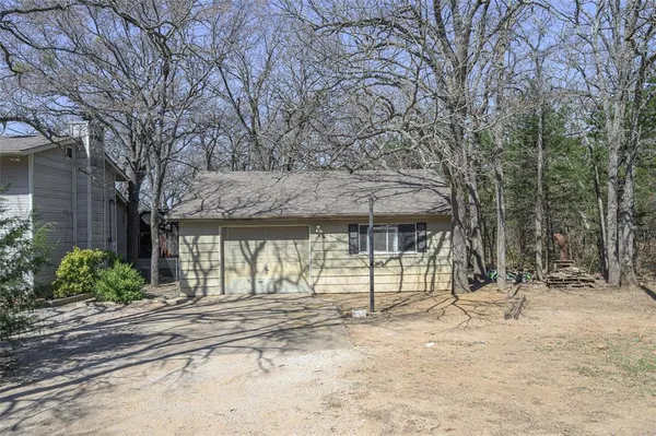 a view of a backyard with large trees