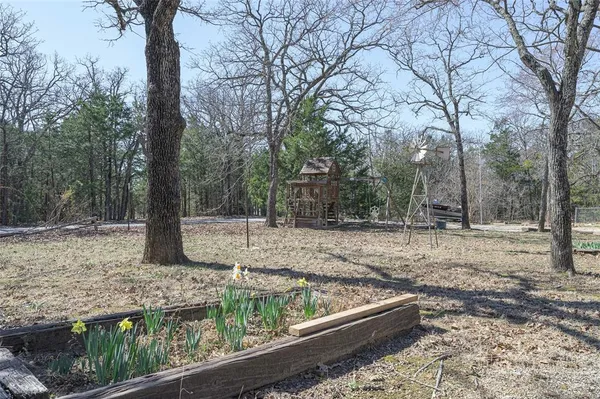 a view of a yard with trees