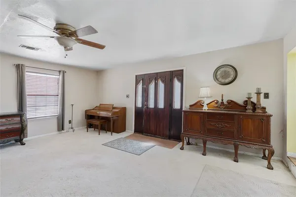 a view of a livingroom with furniture and a window