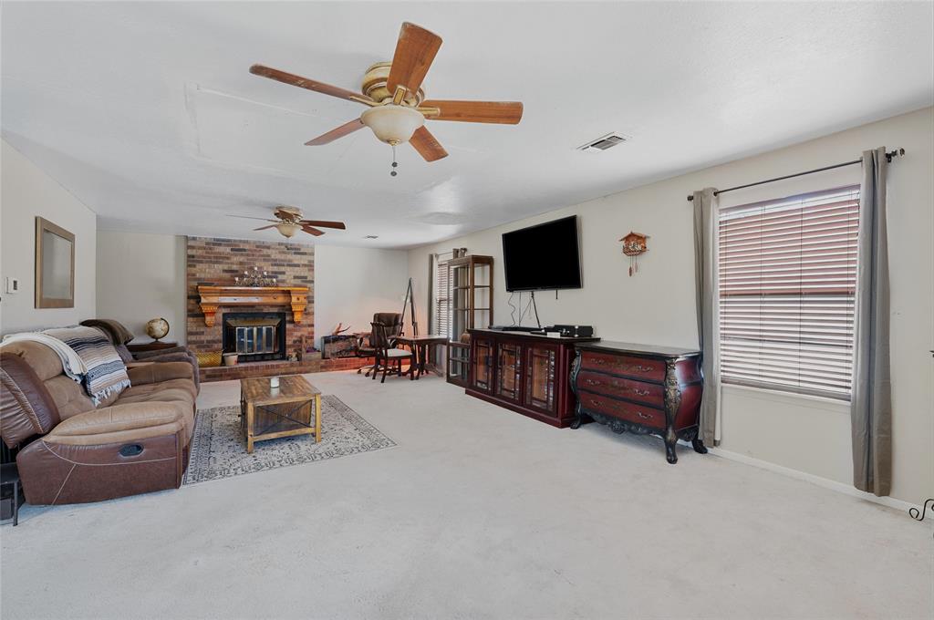 101 Frazier Oaks Road Pottsboro, TX 75076 - Photo 9 of 36 a living room with furniture and a flat screen tv