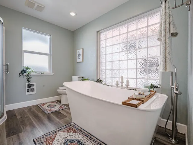 a bath room with a sink and a window