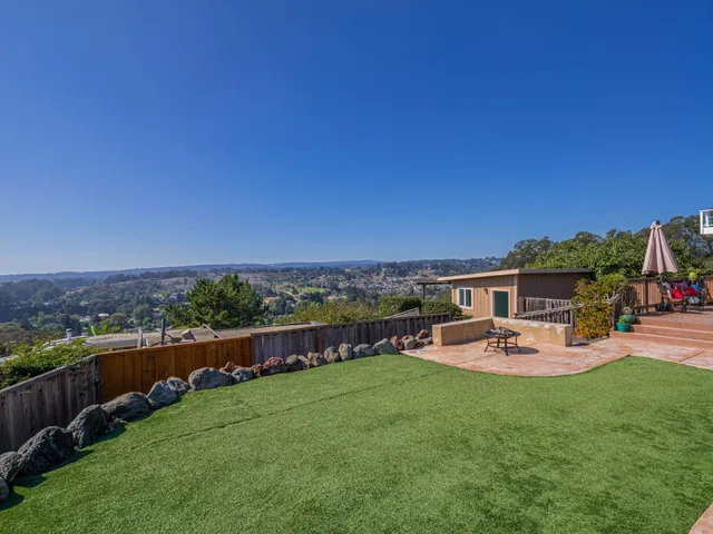 a view of a swimming pool and lounge chairs in the garden