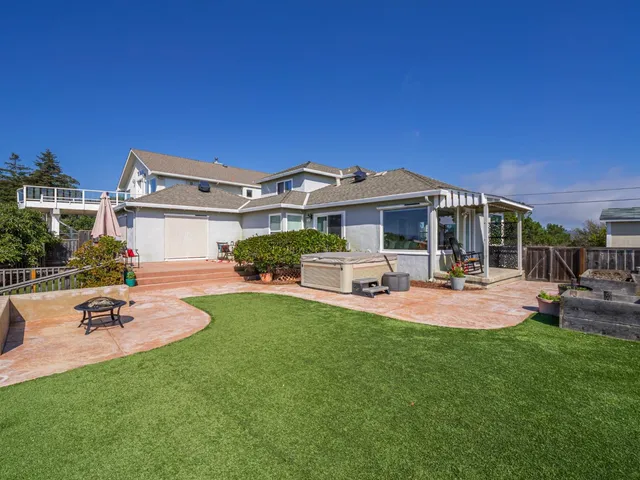 a view of a house with swimming pool and sitting area