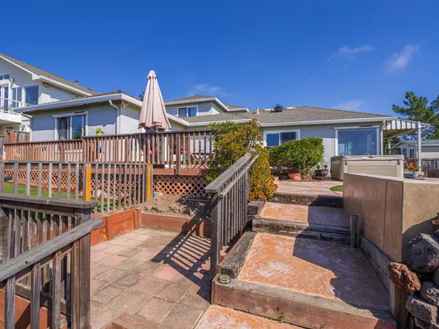 a view of a house with wooden deck