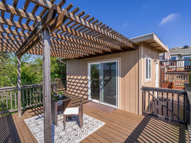 a porch with a table and chairs