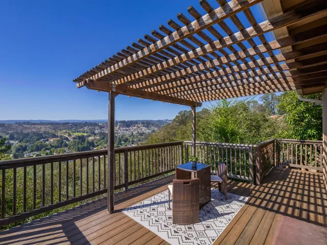 a view of a roof deck with wooden floor and outdoor seating