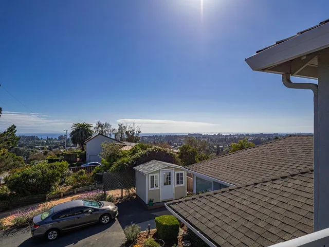 an aerial view of multiple houses with yard