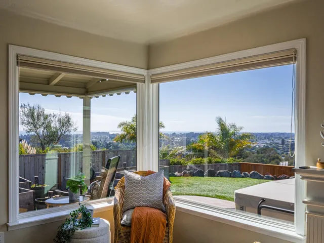 a living room filled with furniture and a floor to ceiling window