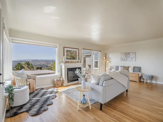 a living room with furniture a fireplace and a table