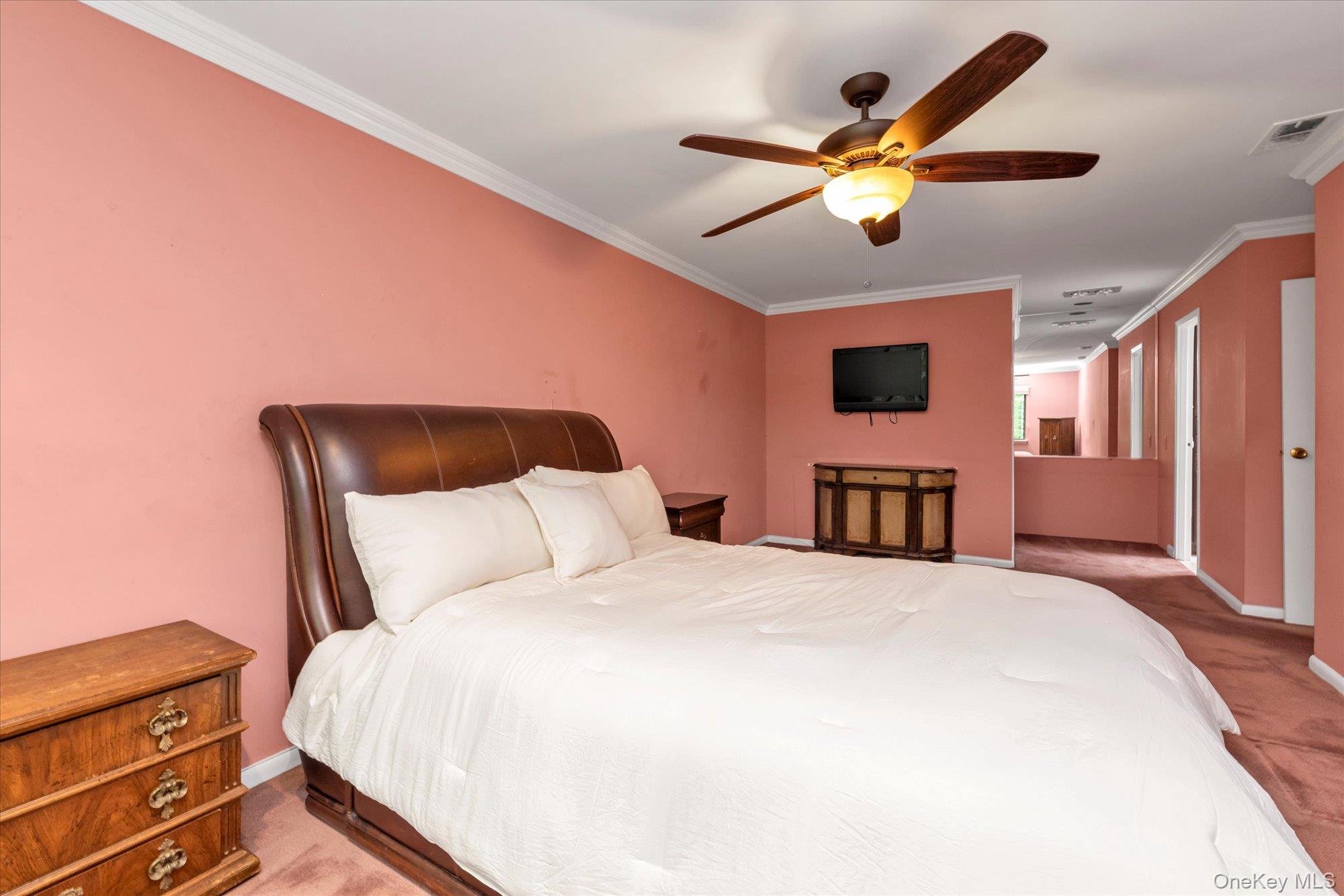 41 Spring Hollow Road Roslyn, NY 11576 - Photo 13 of 27 a bedroom with a large bed and a chandelier