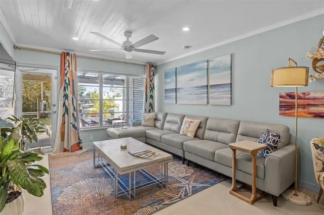 a living room with furniture fireplace and large windows