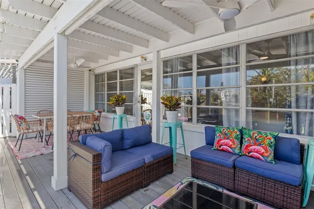 a living room with furniture a rug and a window