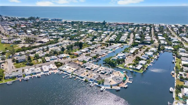 an aerial view of a house with a lake