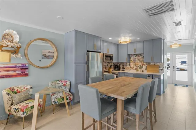a kitchen with a table and chairs in it