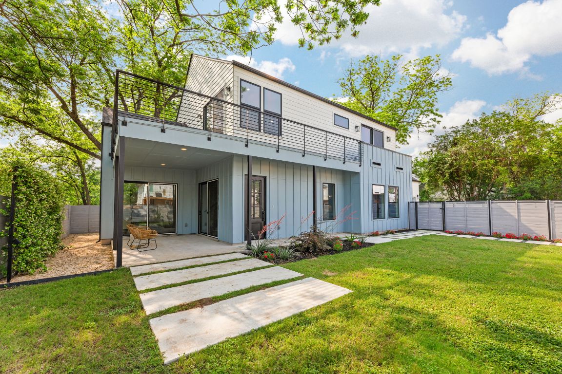 a view of a house with a yard and plants
