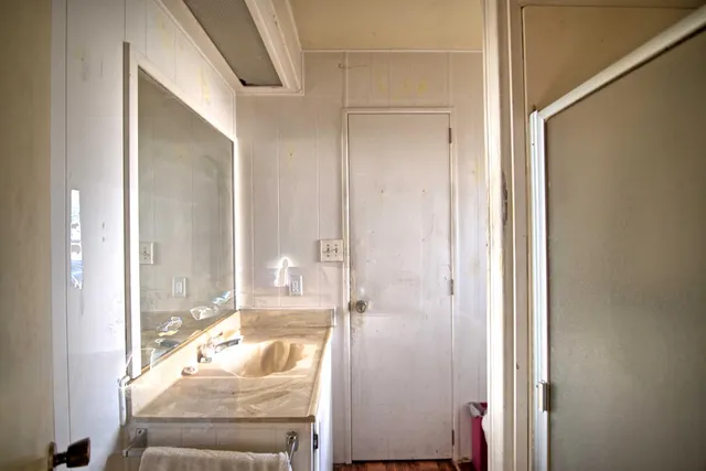 a bathroom with a tub shower and sink