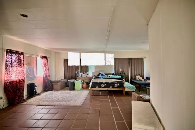 a living room with furniture a window and a table