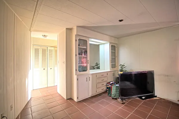 a living room with a mirror and furniture
