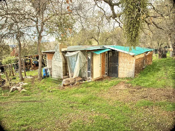 a view of a house with backyard and sitting area