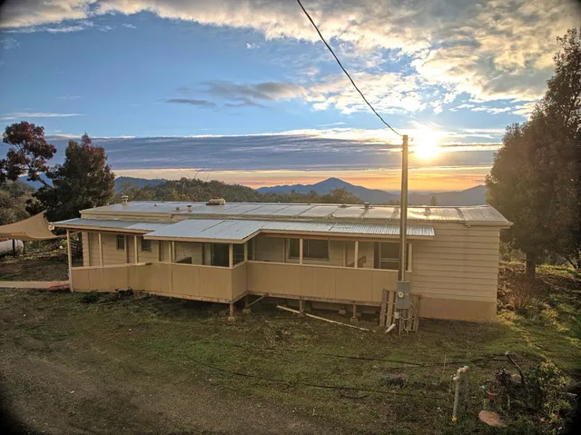 a view of a big house with a yard