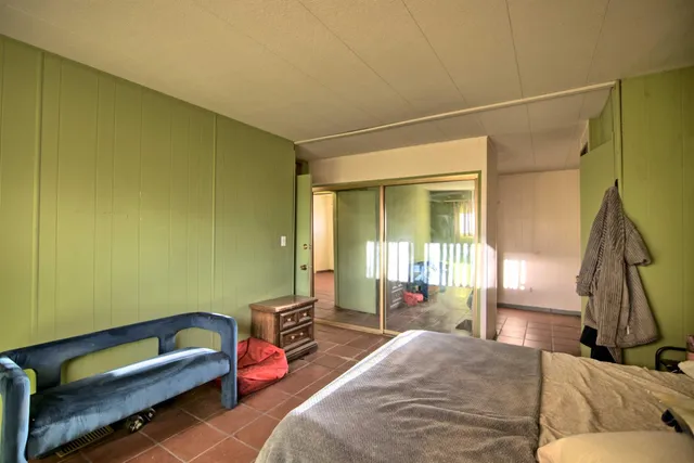 a bedroom with a bed and a couch