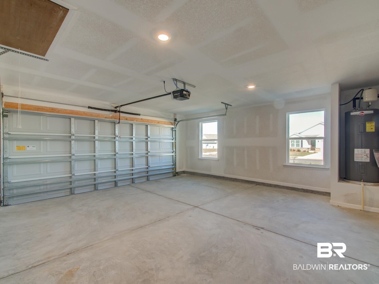 23953 Citation Loop Daphne, AL 36526 - Photo 30 of 49 Garage with electric water heater, recessed lighting, and a garage door opener