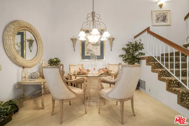 a view of a dining room with furniture and a chandelier