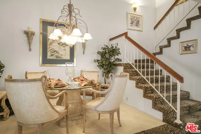 a view of a dining room with furniture and a chandelier