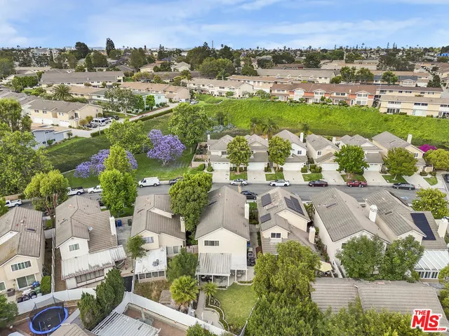 an aerial view of lake residential house with outdoor space and swimming pool