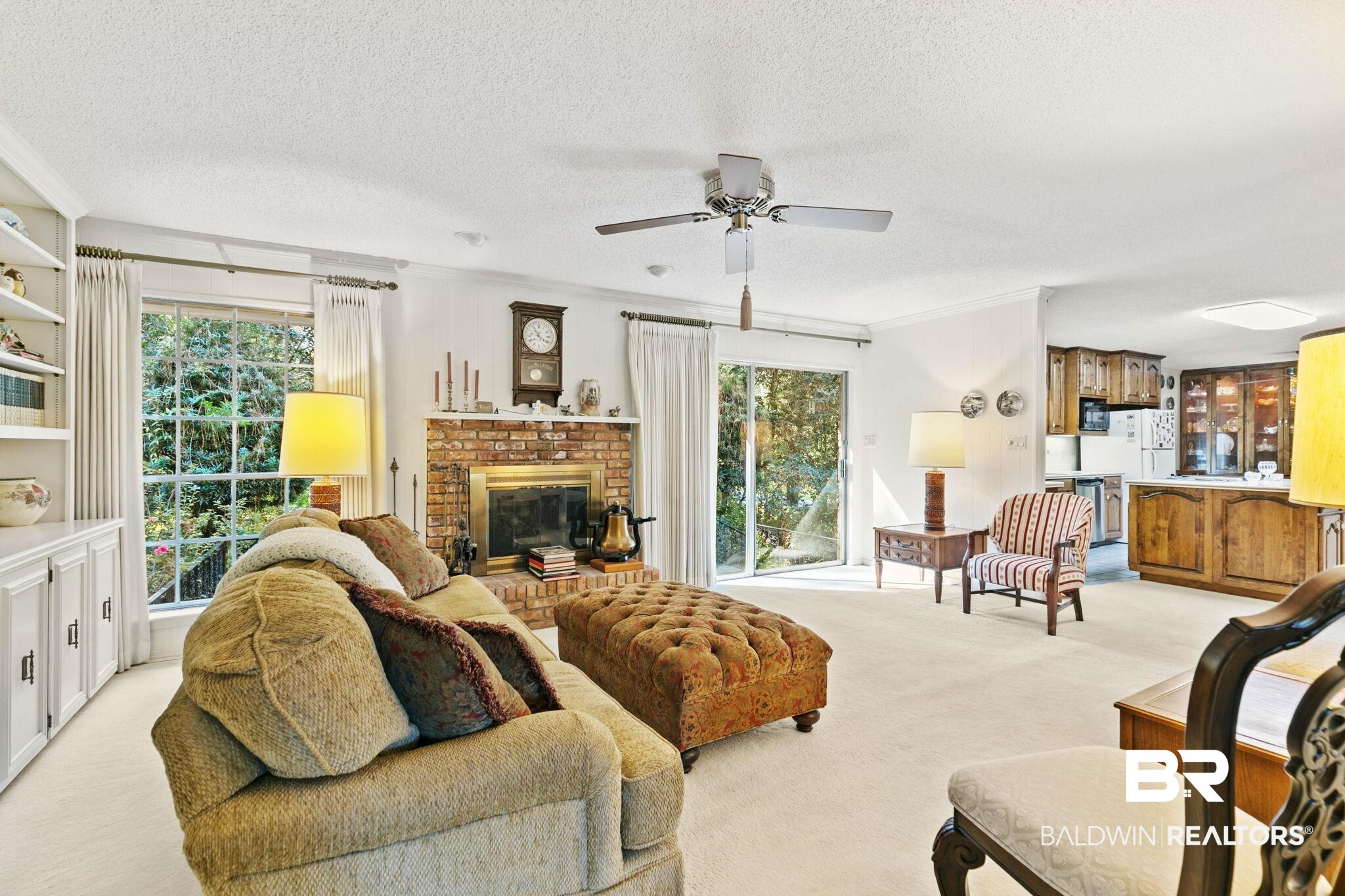 752 Evergreen Street Fairhope, AL 36532 - Photo 23 of 100 Living area with light carpet, a textured ceiling, healthy amount of natural light, a fireplace, and a ceiling fan