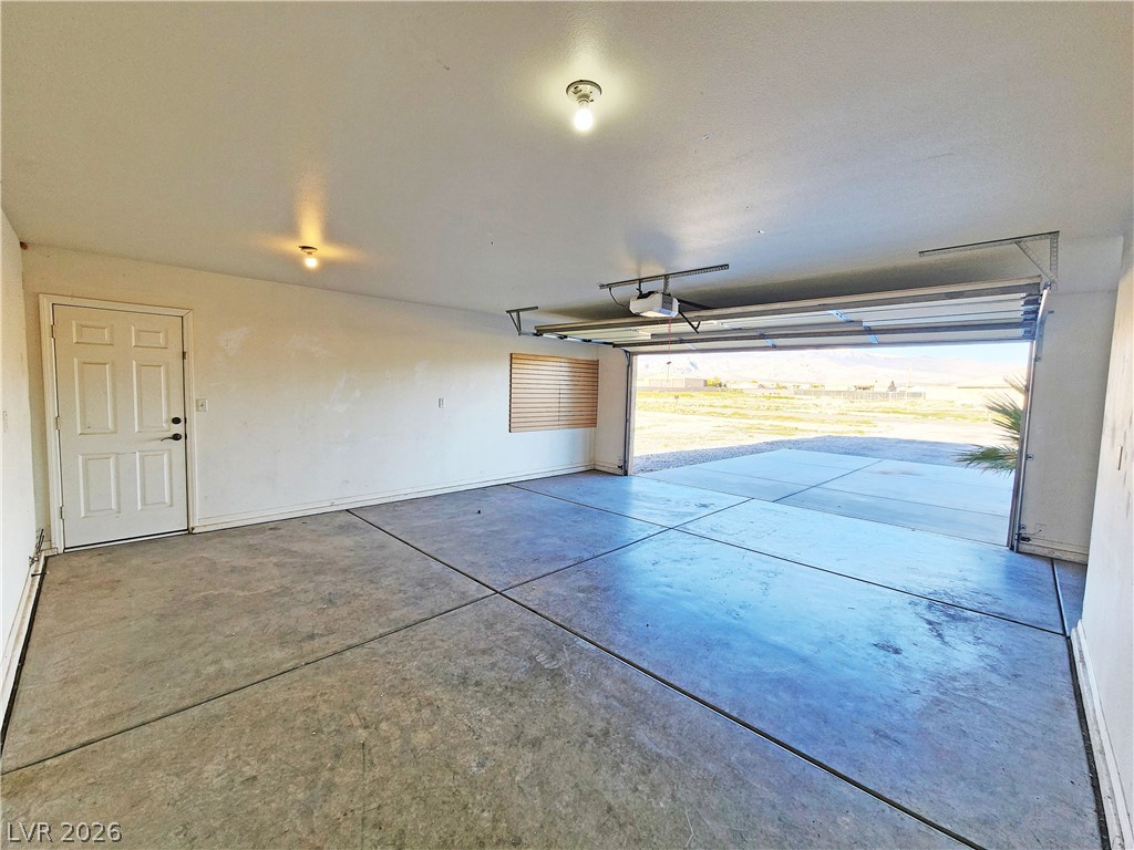 3680 Ravine Avenue Pahrump, NV 89048 - Photo 26 of 28 Garage with a garage door opener and baseboards