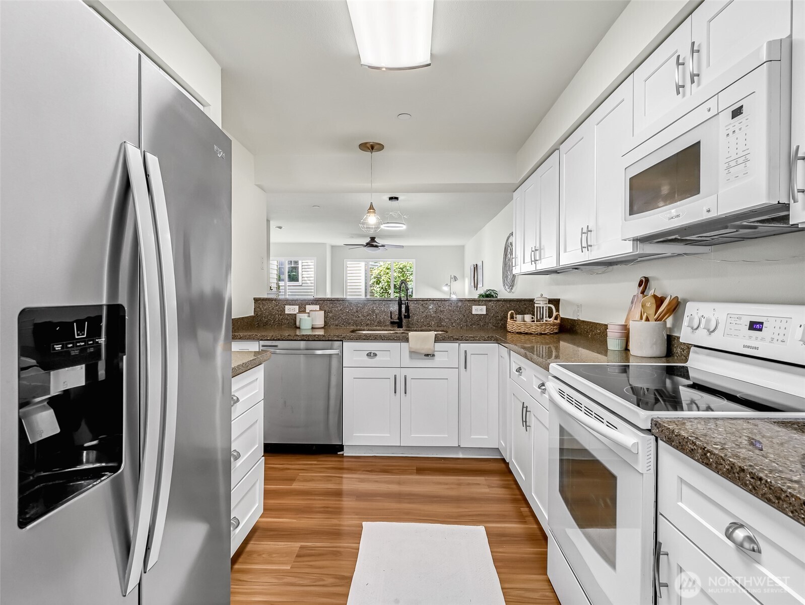 2300 Jefferson Avenue Northeast, Unit I137 Renton, WA 98056 - Photo 15 of 40 a kitchen with stainless steel appliances granite countertop a refrigerator sink and stove