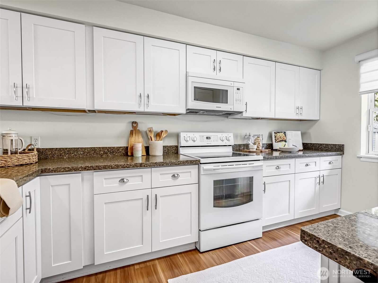 2300 Jefferson Avenue Northeast, Unit I137 Renton, WA 98056 - Photo 16 of 40 a kitchen with granite countertop white cabinets and white appliances