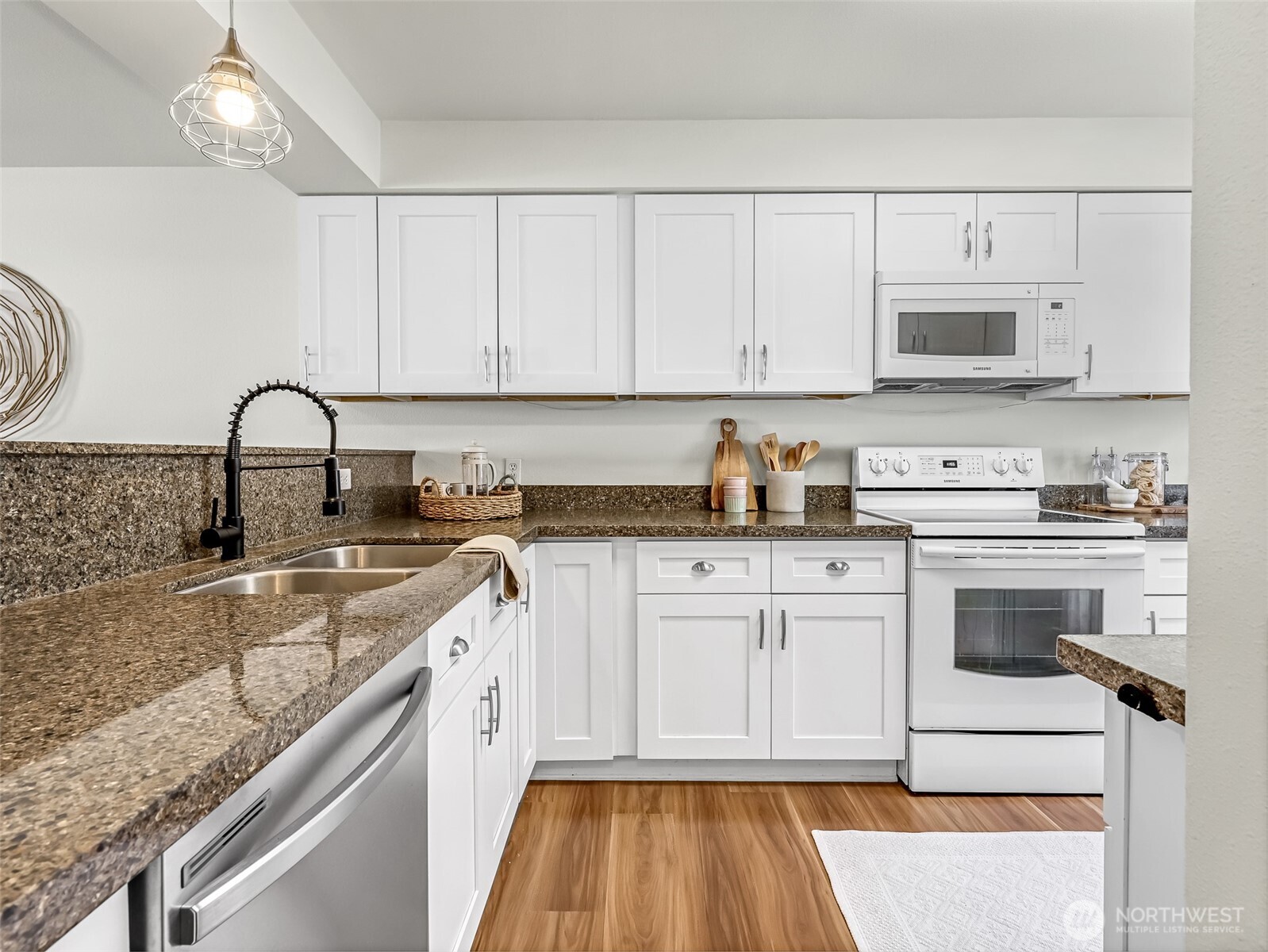 2300 Jefferson Avenue Northeast, Unit I137 Renton, WA 98056 - Photo 18 of 40 a kitchen with granite countertop white cabinets and white appliances