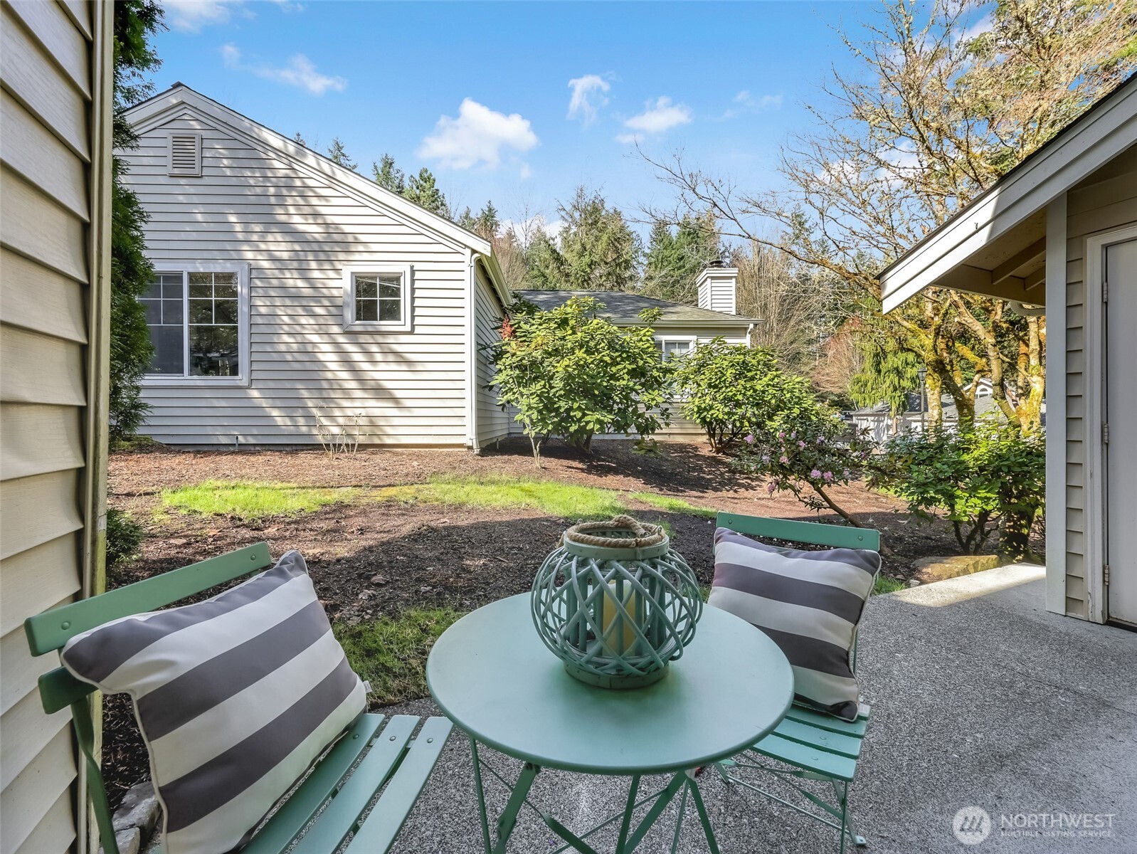 2300 Jefferson Avenue Northeast, Unit I137 Renton, WA 98056 - Photo 35 of 40 a view of a patio with table and chairs and potted plants with wooden floor and fence