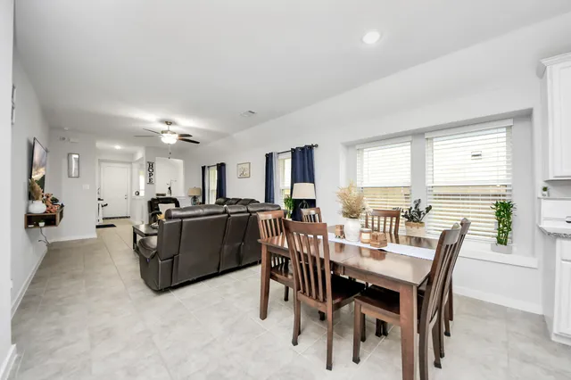 a view of a dining room with furniture and a large window