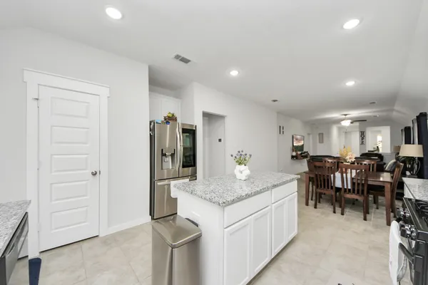 a open kitchen with stainless steel appliances granite countertop a stove and a sink
