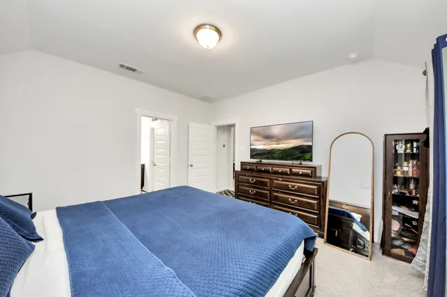 a bedroom with furniture and flat screen tv