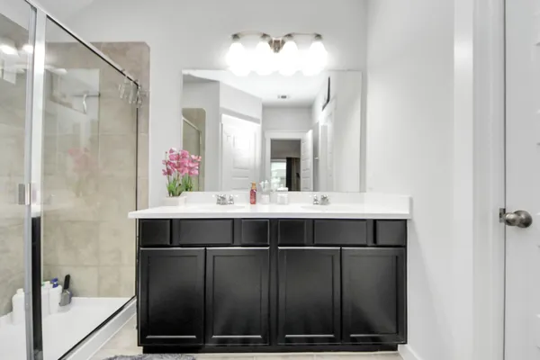 a bathroom with a sink vanity and a mirror